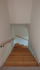 Příklad realizace u zákazníka - madlo dubové lakované s černými úchyty Příklad realizace u zákazníka - madlo dubové lakované s černými úchyty